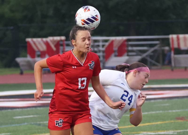Timothy Christian's Mackenzie Laslo heads the ball over Johnsburg's Natalie Oeffling Thursday, June 5, 2025, during their IHSA Class 1A state semifinal at North Central College in Naperville.