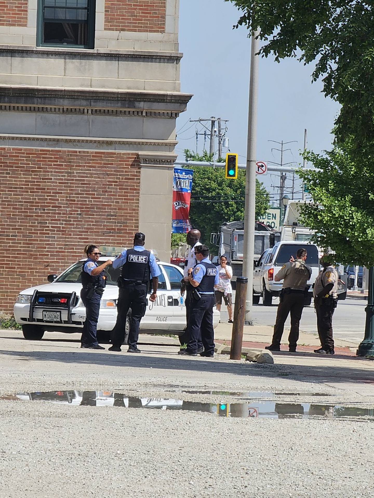 Will County sheriff's deputies and Joliet police officers in downtown Joliet following the apprehension of Francisco Nasario Maradiaga, 30, on probable cause of possessing a stolen firearm.