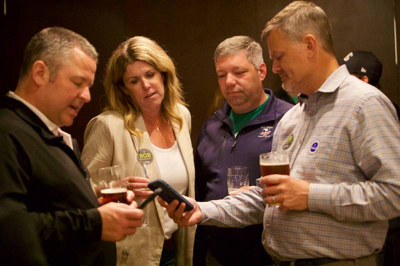 Supporters for Downers Grove Mayor Bob Barnett gather together as poll results come in at Emmett's Brewing on Tuesday, April 4,2023 in Downers Grove.