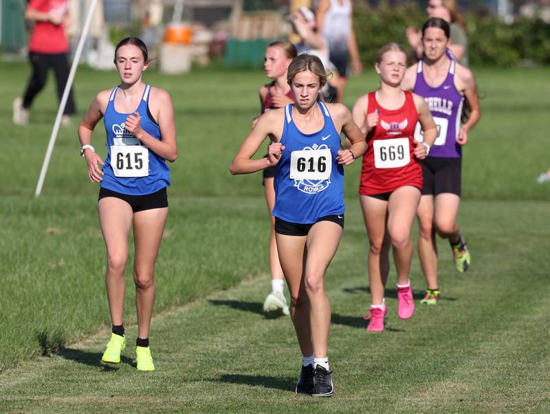 Hinckley-Big Rock’s Isabella Canzoneri (left) and Zeta Fay run side by side in the girls varsity race Tuesday, Sept. 2, 2025, during the Sycamore Cross Country Invitational at Northern Illinois University in DeKalb.