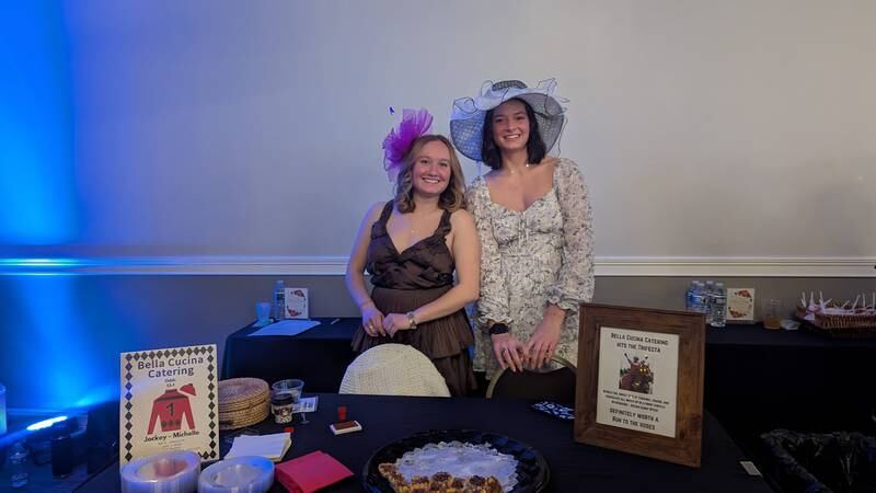 Kaylie Mahoney of Wheaton, a nice of Sue Coyle, one of the founders of Shorewood HUGS, and Adelina Sauder of Tremont, pose behind the Bella Cucina Catering table at the Shorewood HUGS chocolate ball on Saturday, February 1, 2025, in Joliet.