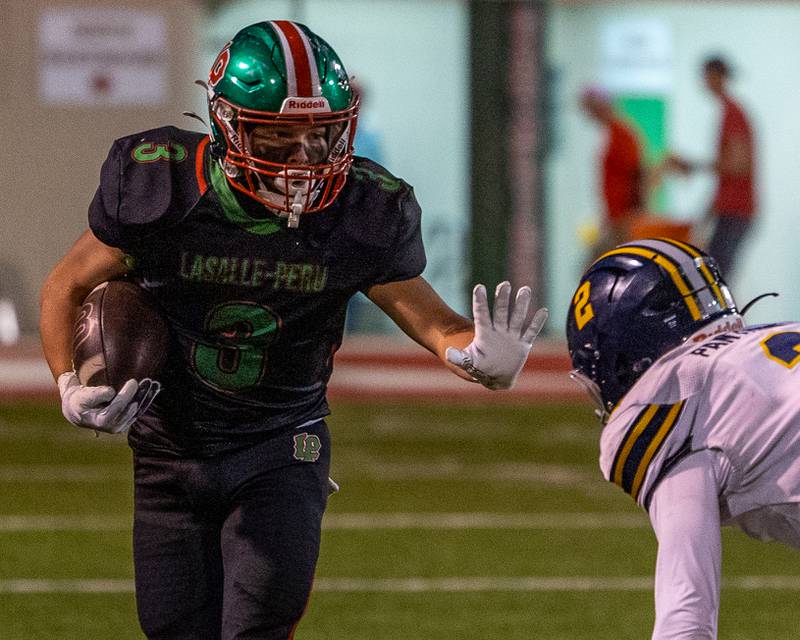 Rylynd Rynkewicz (3) of L-P sticks hand out in defense as he runs ball on Friday, October 24, 2025 at Howard Fellows Stadium in LaSalle.