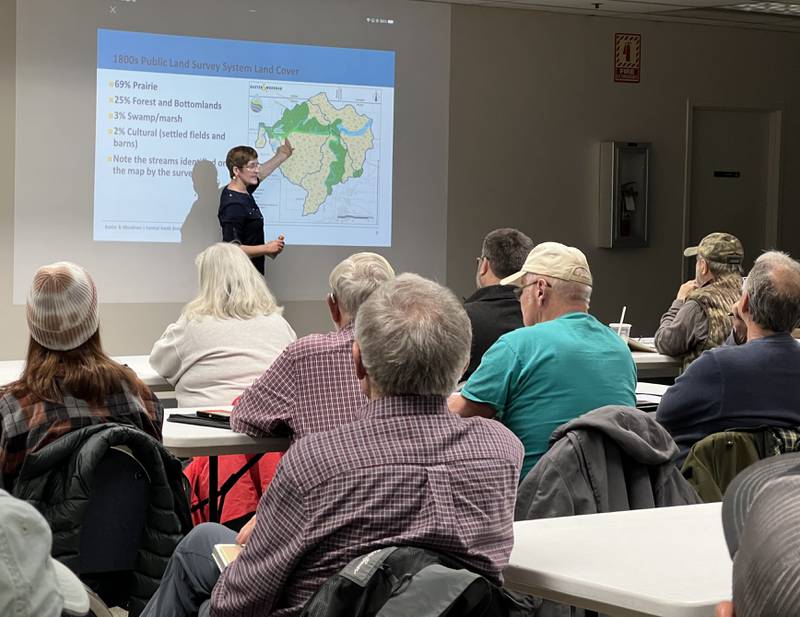 Cecily Cunz, with Baxter & Woodman Consulting Engineers, points at a map of the Central South Branch Kishwaukee River watershed during a public meeting held for the creation of a watershed plan on April 18, 2024, in Genoa.