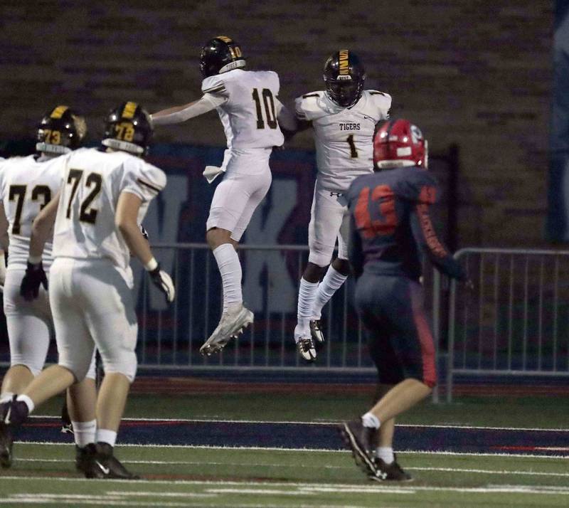 Joliet West’s Carl Bew (1) and Parker Schwarting (10) celebrate a touchdown against West Aurora Thursday September 15, 2022 in Aurora.