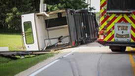 Driver injured after truck and trailer roll over near Harvard