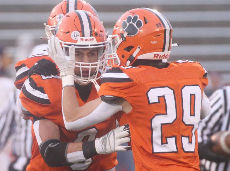 Byron's Carter Groharing reacts with teammate Kye Aken after intercepting a ball against Mt. Carmel during the Class 3A State football championship on Friday, Nov, 24, 2023 at Hancock Stadium in Normal.