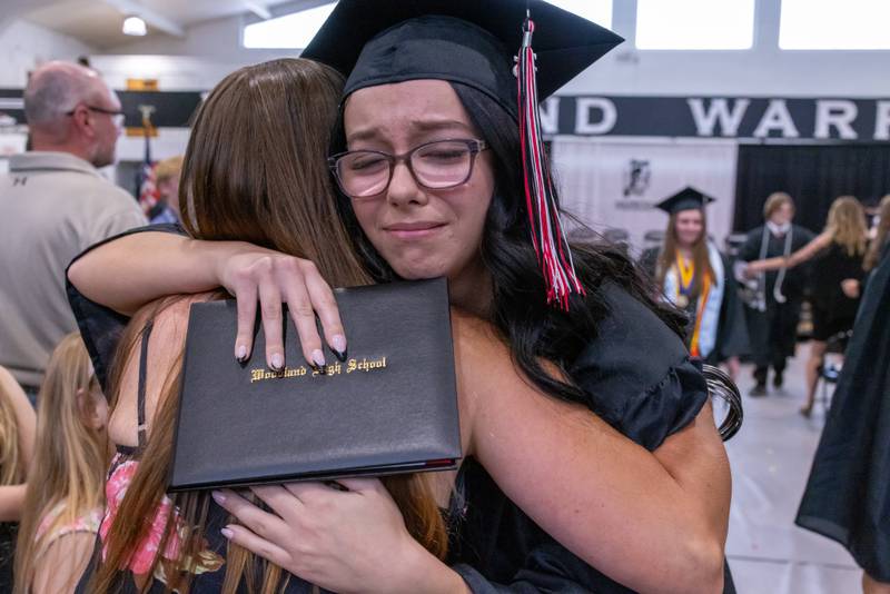 Hannah Snow receives an emotional congratulatory hug as she walks out following graduation during the Woodland High School Class of 2025 commencement ceremony on Sunday, May 18, 2025 at Woodfield High School.