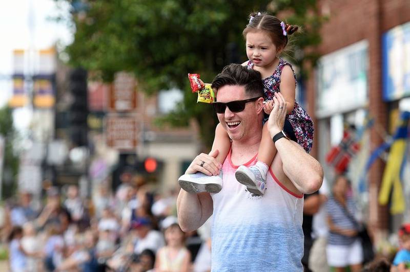 Dan Janes gives his daughter Adeline, 2, a better view of the action Sunday during Geneva's Swedish Days parade.