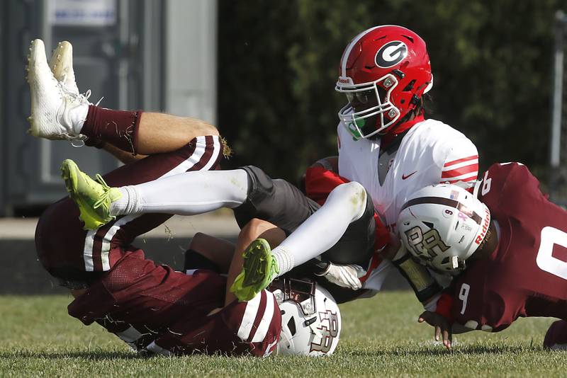 Prairie Ridge's Andrew Koeppen and Michael Meade tackle Chicago Goode's Zacharias Pagan to stop an extra point attempt during an IHSA Class 5A first-round football game on Saturday, Nov. 2, 2024, at Prairie Ridge High School in Crystal Lake.