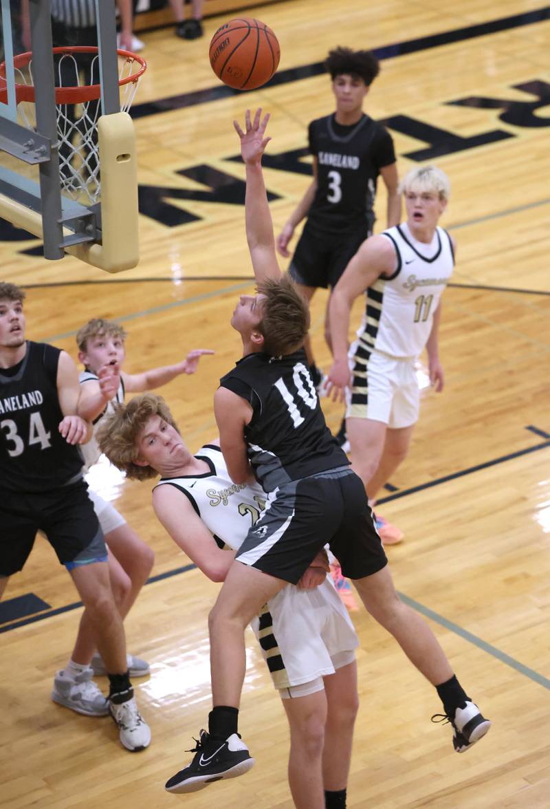 Kaneland's Troyer Carlson runs into Sycamore's Lucas Winburn as he goes to the basket during their game Friday, Feb. 10, 2023, at Sycamore High School.