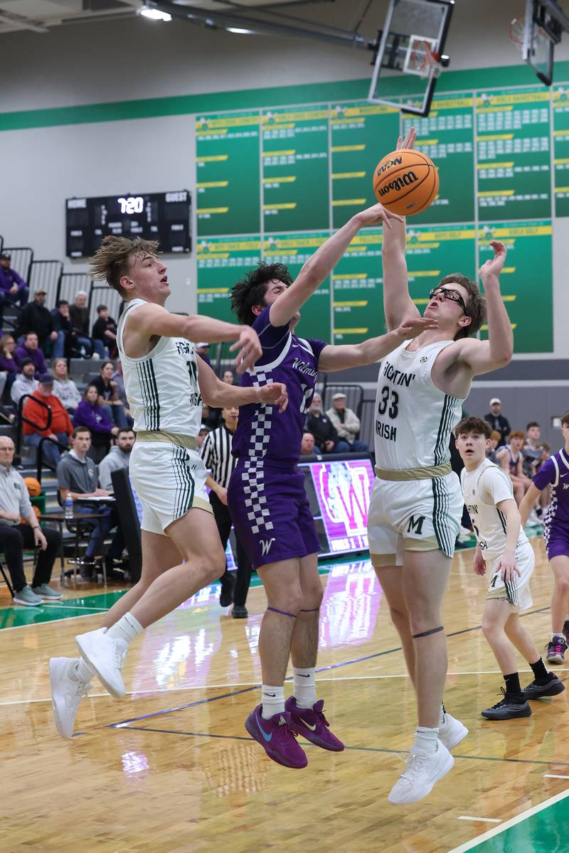 Bishop McNamara's Coen Demack, left, and Callaghan O'Connor, right, knock the ball away from Wilmington's Ryan Kettman during Bishop McNamara's 61-24 victory over Wilmington in the IHSA Class 2A Seneca Sectional semifinal on Tuesday, March 3, 2026.