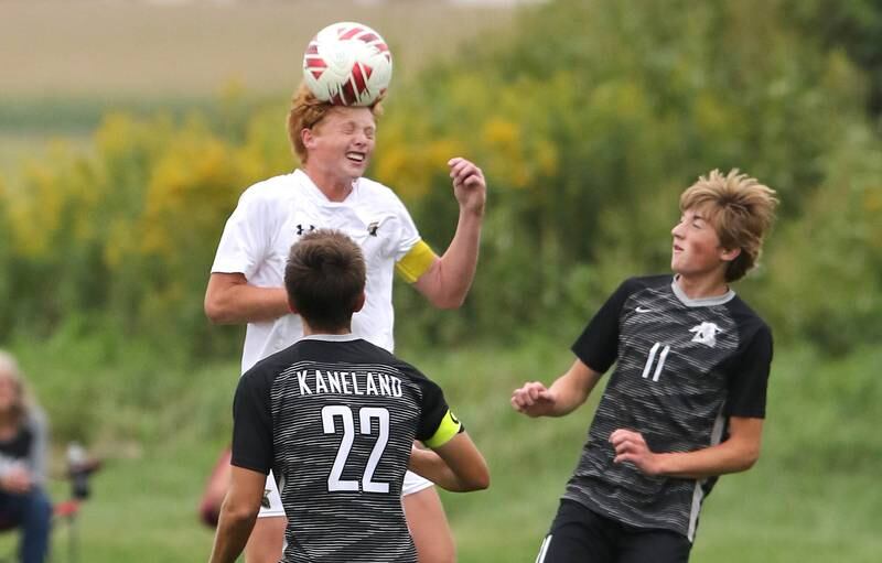 Sycamore's Jameson Carl heads the ball between Kaneland's Tommy Watson and Matthew Mitchinson during their game Wednesday, Sept. 6, 2023, at Kaneland High School in Maple Park.