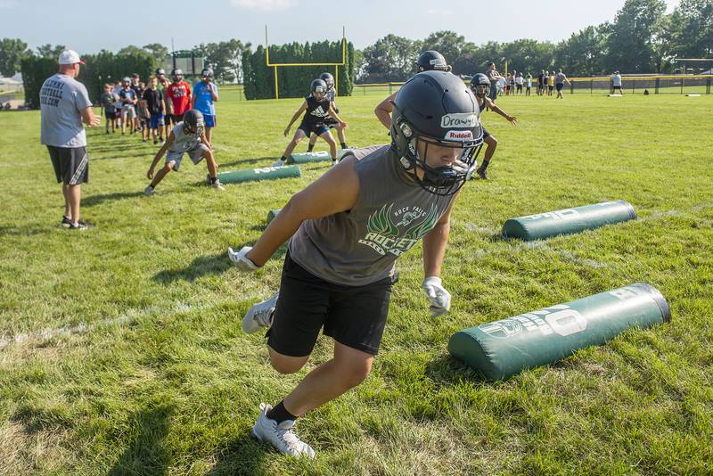 Rock Falls football camp members run through stretching drills Tuesday, July 19, 2022. Players of all ages attended the camp ahead of the upcoming season.