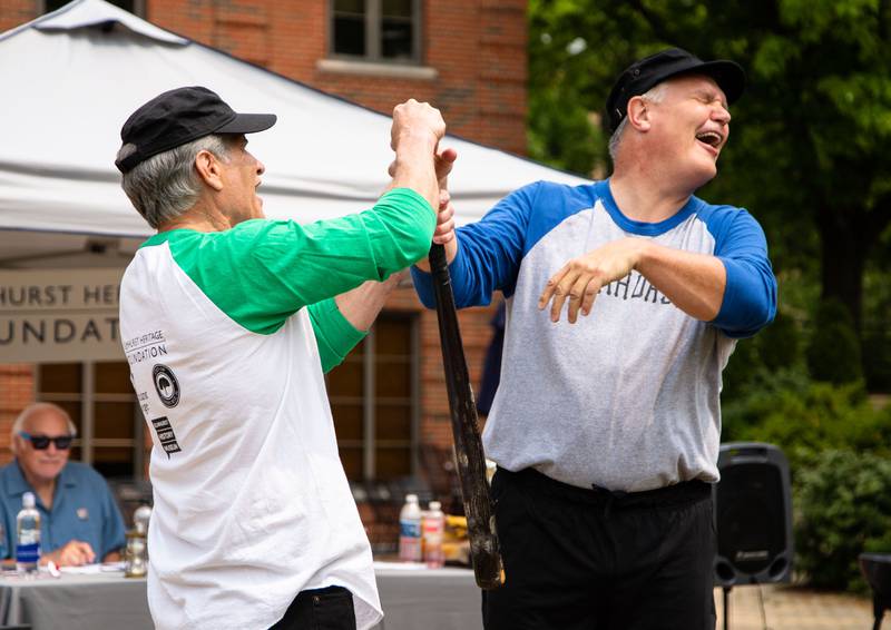 Elmhurst Mayor Scott Levin, left, wins the bat toss before the Elmhurst Heritage Foundation's Vintage Baseball Game at Elmhurst University Mall on Sunday, June 4, 2023. Both teams from the city of Elmhurst and Elmhurst University played with baseball rules from 1850.