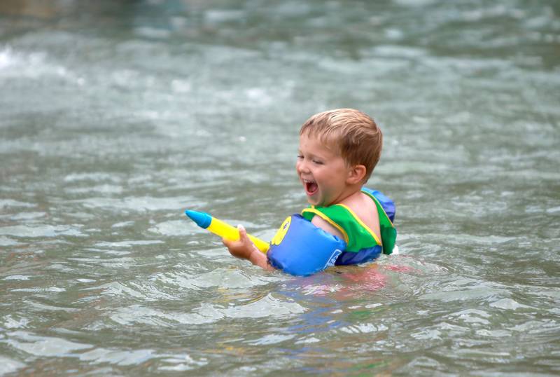 Three-year-old Colton Powell squirts water while playing at the Batavia Park District’s Hall Quarry Beach on Thursday, June 13, 2024.