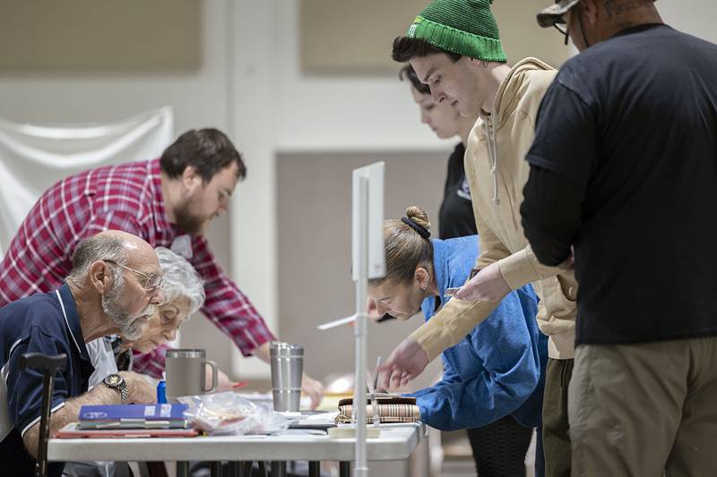 Members of the Brumbly family Toni, Angie, Dylan and Tris check in at their precinct to vote Tuesday, Nov. 8, 2022.