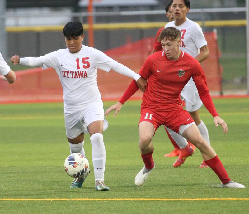 Ottawa's Michael Bedolla kicks the ball away from L-P's Jason Curran Jr. on Monday, Sept. 11, 2023 at the L-P Athletic Complex in La Salle.