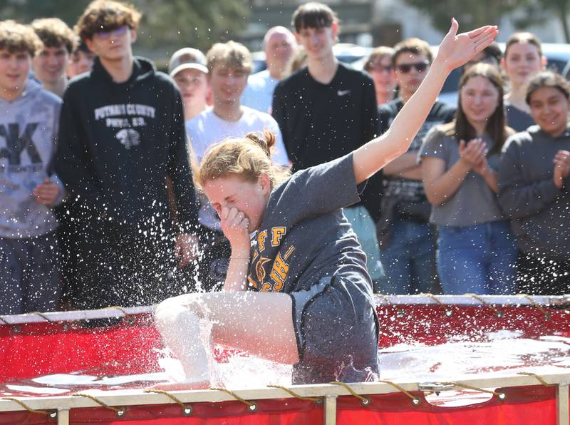 Brianna Lenger speech pathologist at Putnam County High School, jumps into a water tank during the Polar Plunge to support Special Olympics on Friday, March 14, 2025 at Putnam County High School.