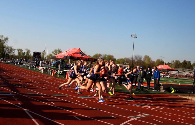 Runners take off for the 3200-meter run in the 2024 Kane County Girls Track and Field meet at St. Charles East on Thursday, April 25, 2024.