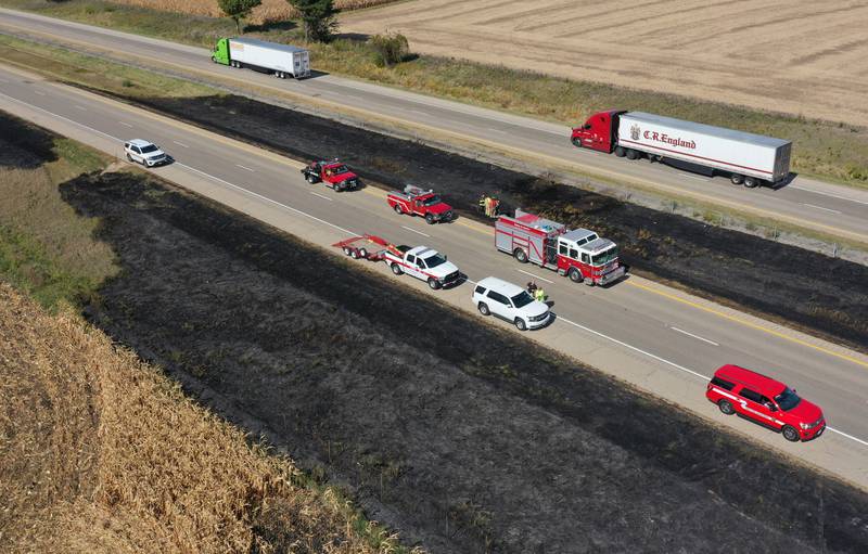 Firefighters extinguish a brushfire on Wednesday, Oct. 9, 2024 along Interstate 80 in the eastbound lane near mile post 65 in Bureau County. A MABAS box alarm was sent out around 11:45 a.m. and upgraded to a fourth-alarm. Interstate 80 was shut down in the Eastbound lane while firefighters doused the flames. Fire companies from Utica, Oglesby, Ladd, Bureau, Hennepin, Peru, La Salle, Spring Valley and others responded to the scene.