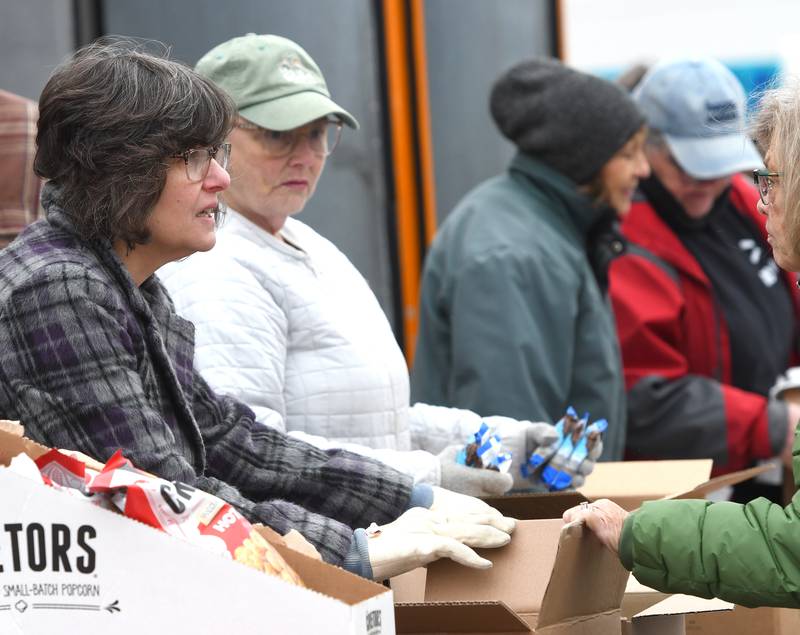 Director Kathy Wragg (left) talks to a woman as volunteers from the Polo Lifeline Food Pantry help distribute food items on Wednesday, Nov. 19, 2025 from the Northern Illinois Food Bank's mobile market truck.