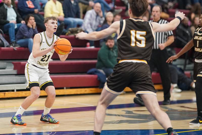 Yorkville Christian's Jordan Purvis (21) spots up for a three point shot against Joliet Catholic's Brady Tunkel (15) during a basketball game at Yorkville Christian High School on Monday, January 13, 2025.
