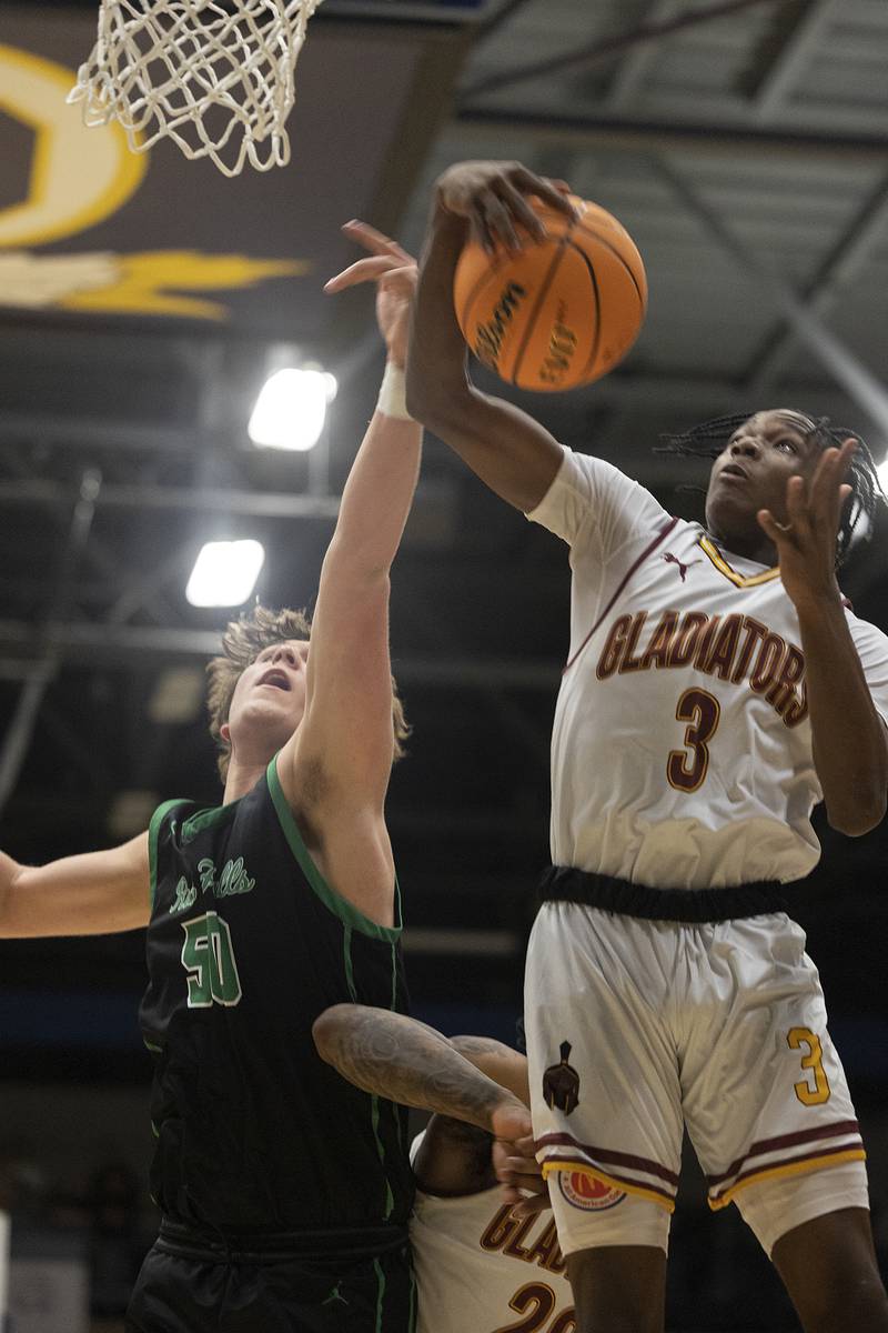 Rock Falls’ Cole Mulnix has a rebound grabbed away by Christ the King’s Mike Thomas Monday, March 10, 2025, during the Class 2A boys basketball Supersectional in Sterling.