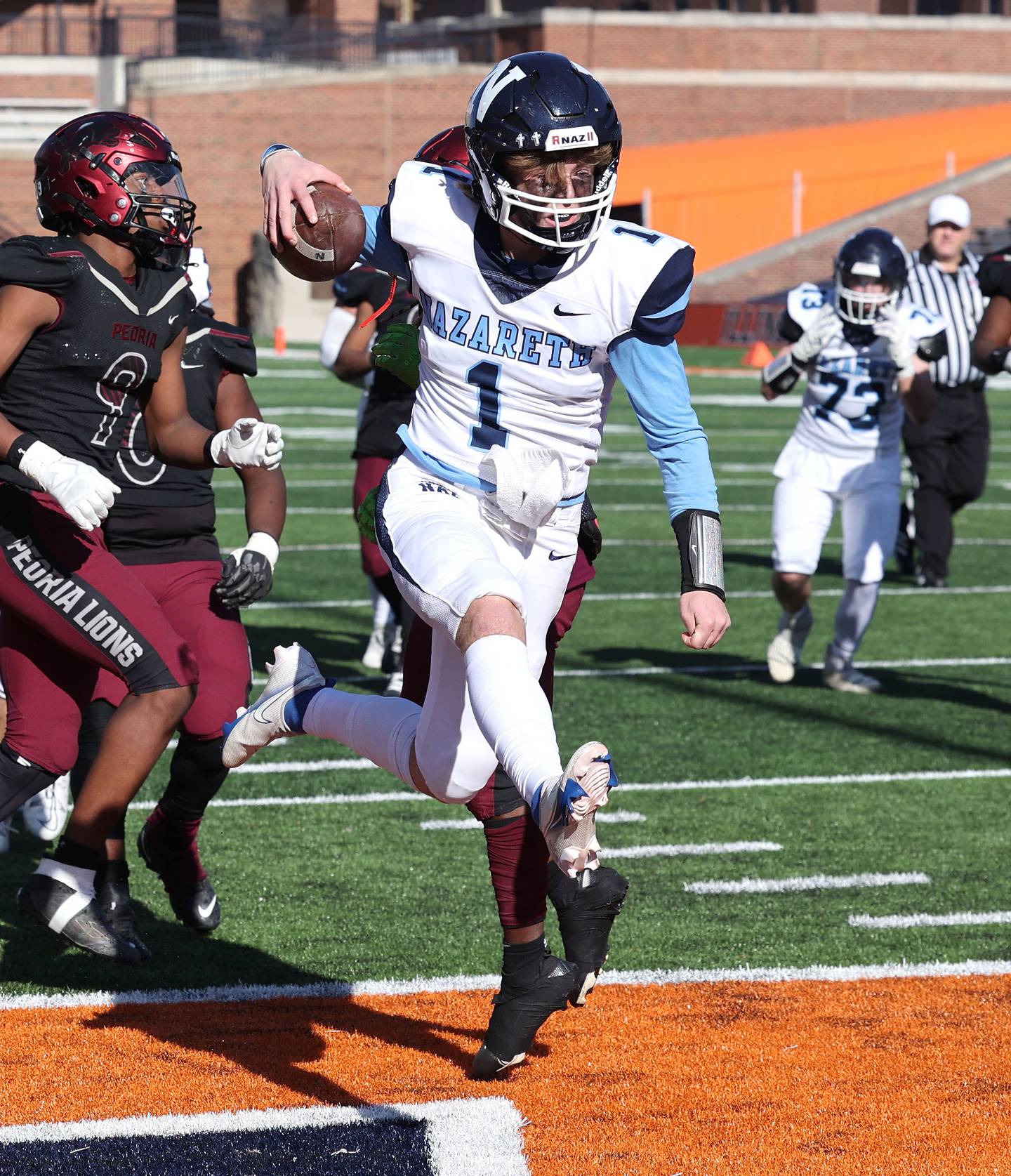 Nazareth's Logan Malachuk leaps across the goal line for a touchdown during their IHSA Class 5A state championship game against Peoria Saturday, Nov. 26, 2022, in Memorial Stadium at the University of Illinois in Champaign.