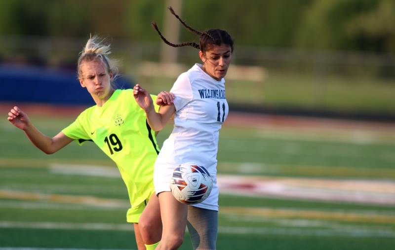 Richmond-Burton’s Layne Frericks, left, battles Willows’ Izzy Avila in Class 1A Sectional title soccer action at Richmond Friday night.