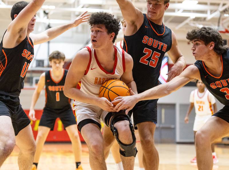 Batavia guard Josh Kahley attempts to keep possession of the ball during a home game against Wheaton Warrenville South on Tuesday, Jan. 7, 2025.