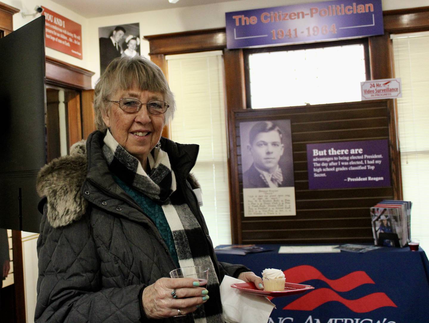 Betty Mull of Sterling enjoys a birthday cupcake and sparkling grape juice on Saturday at the visitor's center at the Ronald Reagan birthday home in Dixon. She came for the free tour along with a friend, Penelope Beardin of Dixon.