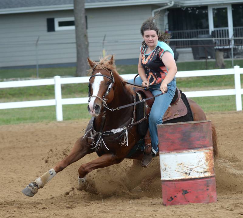 Brynli Dotson, 14, of Washington, Illinois, clears a barrel with her horse Duke in the open division of the barrel competition at the WHOA benefit horse show on Saturday, June 22, 2024 at the Whiteside County fairgrounds in Morrison.