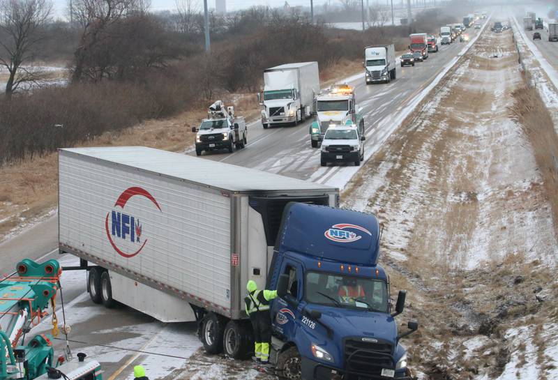 Crews with Senica's Towing pull a semi truck out of the median in the eastbound lane of Interstate 80 near mile marker 82 on Wednesday, Jan .14, 2026 near Utica. Multiple semi tractor trailers were reported in the median between Utica and Ottawa. Interstate 80 remained closed while crews could remove the wreckage from the accident scenes. A fast moving squall line with gusty winds and snow near white-out conditions caused the wrecks.