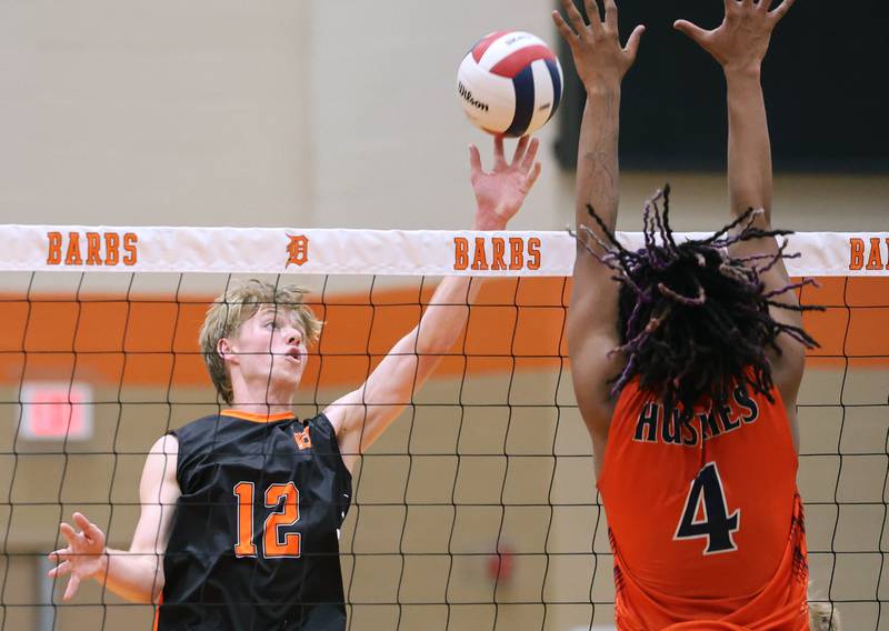 DeKalb’s Gregory Kubitz tips the ball Tuesday, April 21, 2026 during their match against Naperville North JV at DeKalb High School.