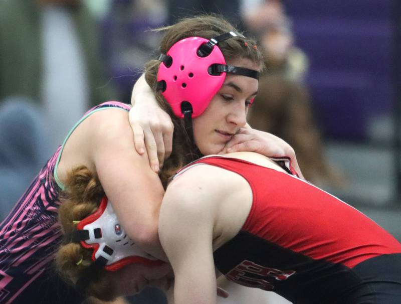 Woodstock’s Hannah Olsen, top, battles Maine South’s Alyssa Gianola at 125 pounds in IHSA Regional wrestling semifinal action on Saturday, Feb. 1, 2025, at  Hampshire High School  in Hampshire.