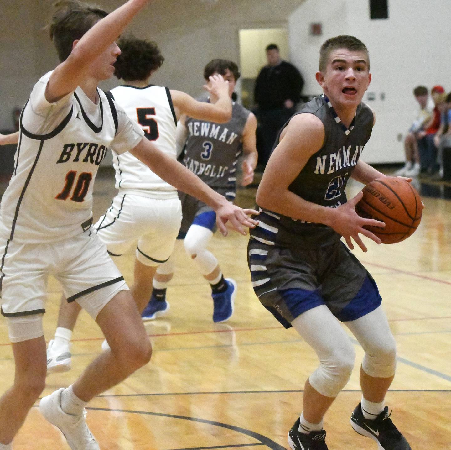 Newman's Cody McBride makes a move to the baslket in the championship game as Byron's Ryan Tucker gives chase at the 62nd Forreston Holiday Tournament on Thursday, Dec. 21, 2023.