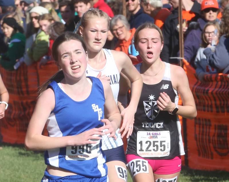 Wheaton St. Francis's Caitlin Twomey (left) and Fenwick's Lily Kotynek (right) compete in the Class 2A State Cross Country race on Saturday, Nov. 4, 2023 at Detweiller Park in Peoria.