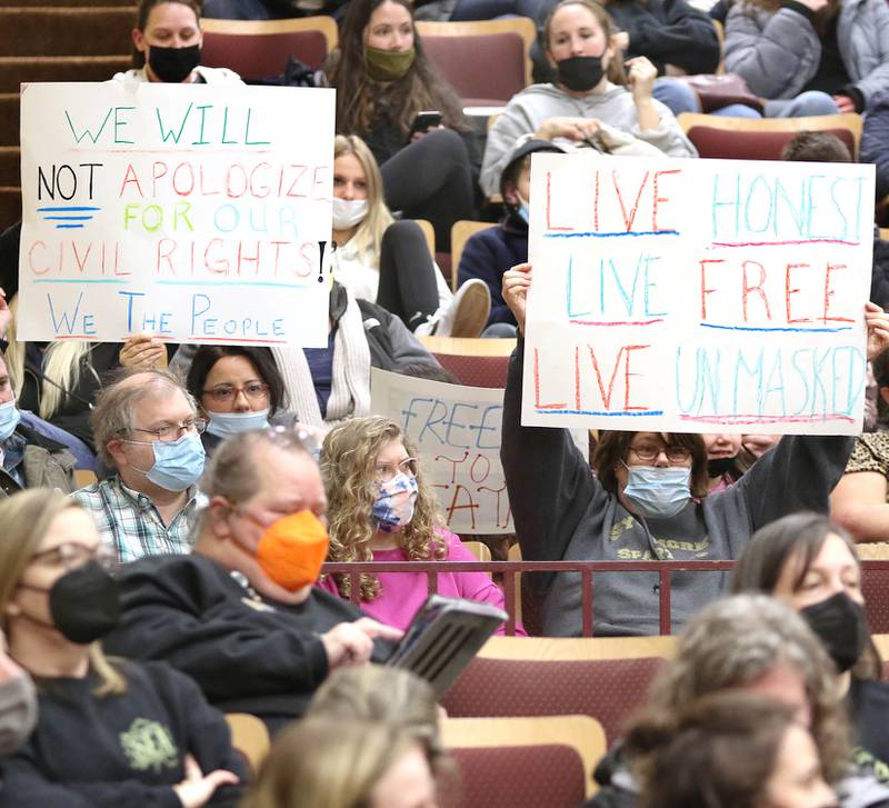 People protest the mask mandate before the start of the Sycamore District 427 school board meeting Tuesday, Feb. 8, 2022, at Sycamore High School. Despite most of the attendees wearing masks the meeting was still halted and switched to a virtual format at a new location after School Board President Jim Dombeck said several maskless individuals refused to comply with districts instruction to wear a face covering.