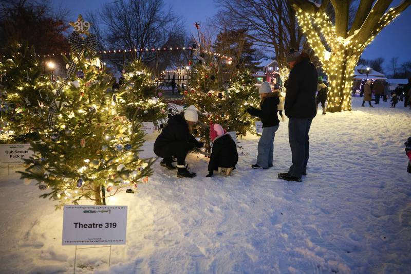 A family builds little snowmen among the Christmas trees at Plainfield’s holiday kickoff Grinchmas on the Green on Saturday, Dec. 5, 2025 in Plainfield.