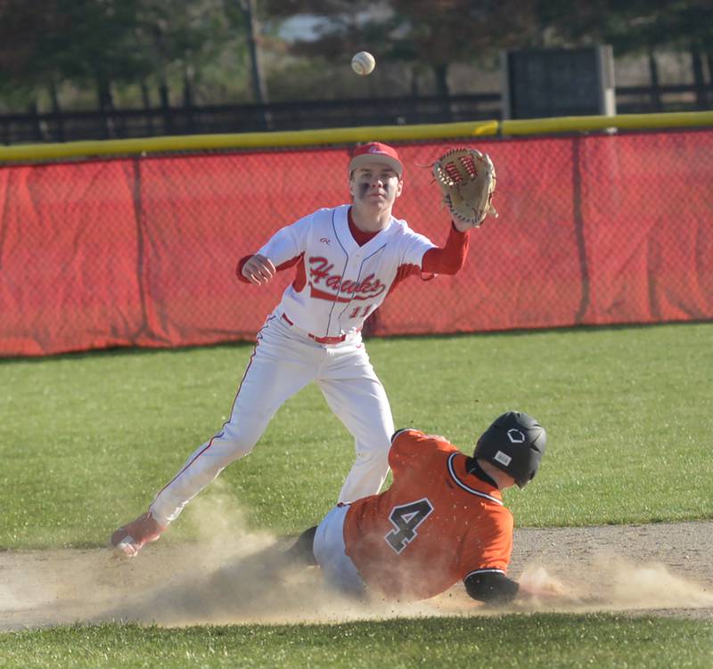 Oregon's Jackson Messenger reaches to catch a throw from the catcher as Byron's Dawson Criddle slides to the  base during a game on Friday, April 12, 2024 at Oregon High School.