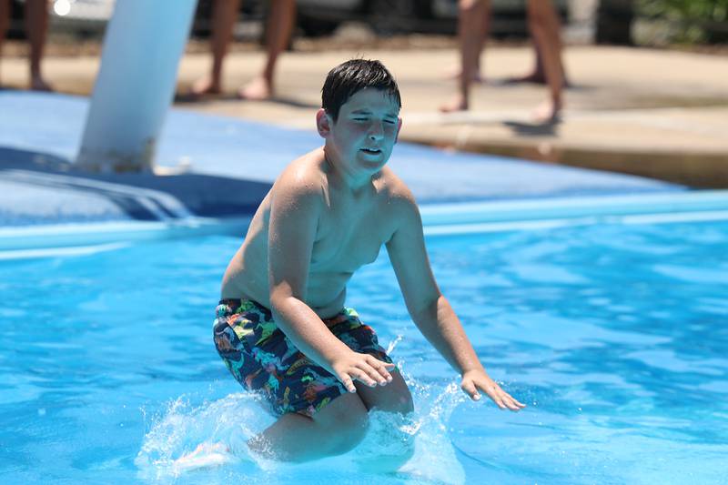 Robbie Becker, 10-years old, jumps into the water at the Ottawa Street Pool in Plainfield. Tuesday, June 14, 2022 in Plainfield.