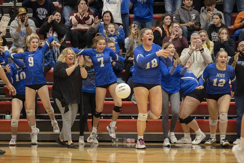 The Newman bench celebrates a straight sets victory in the sectional semifinal Monday, Oct. 31, 2022 against Newark.