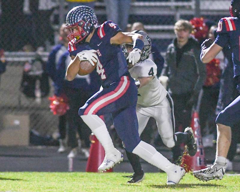 Belvidere North's Ben Bucher (4) gets past Kaneland's Brady Alstott (4) for a touchdown during week one’s playoff game on Friday Nov. 1, 2024, held at Belvidere North High School.