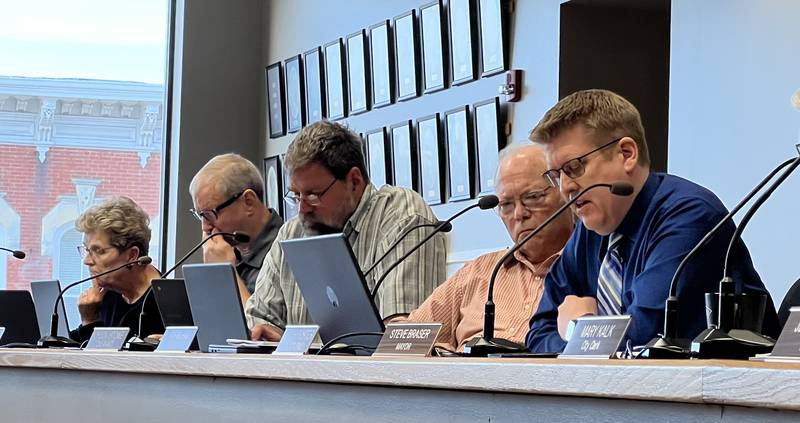 City Manager Michael Hall, Second Ward Alderperson Chuck Stowe, Second Ward Alderperson Pete Paulsen, First Ward Alderperson Alan Bauer and First Ward Alderperson Alicia Cosky look at their city documents on during the May 15, 2023 Sycamore City Council meeting.