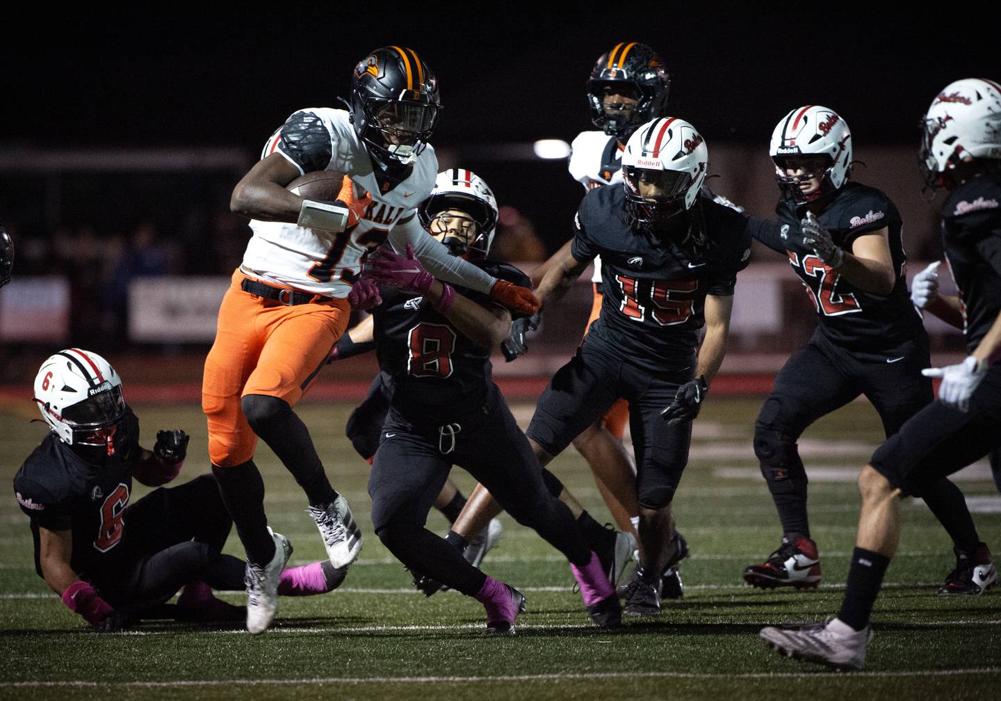 Dekalb's Davon Grant carries the ball on a play as a pack of Bradley-Bourbonnais players try to bring him down in a game on Friday, October 10, 2025.