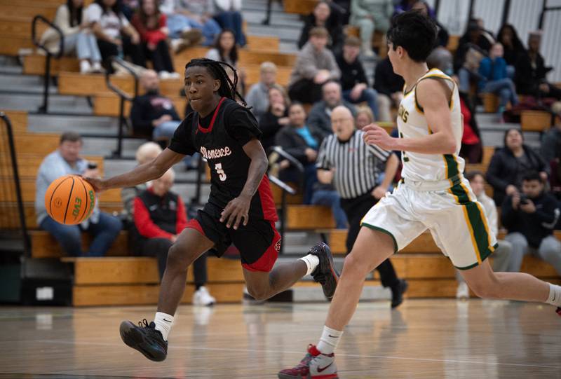 Momence's Aiden Smith, left, leads on a break away as Grant Park's Rigo Venegas, right, follows in a game on Friday, January 16, 2026.