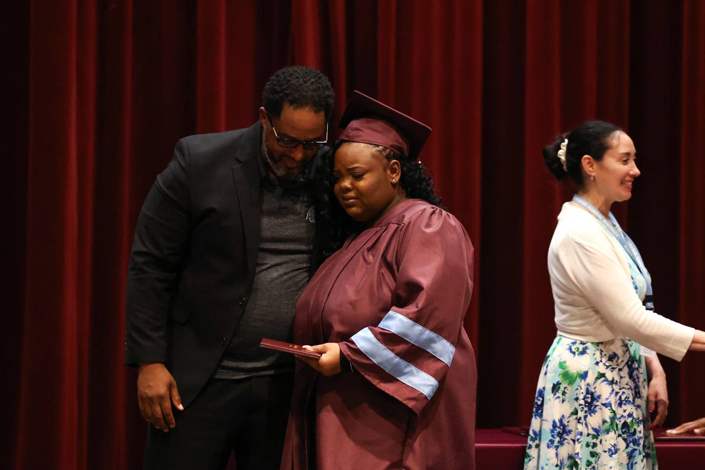 Kankakee High School graduate Lanae Sutton shares an emotional hug with Principal Albert Brass, left, as she receives her diploma during the summer commencement ceremony at the high school on Tuesday, July 29, 2025.