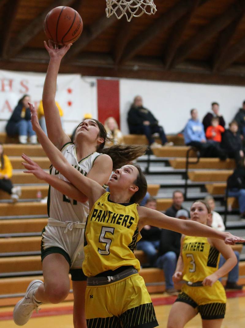 St. Bede's Lily Bosnich eyes the hoop as Putnam County's Eme Bouxsein defends during the Tri-County Conference Tournament championship game on Thursday, Jan. 18, 2024 at Henry-Senachwine High School.