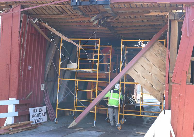 An Illinois Department of Transportation crew begins repairs on the Red Covered Bridge on Monday, Dec. 11, 2023 in Princeton. The bridge was severely damaged when it was struck by a semi truck on Nov. 16.