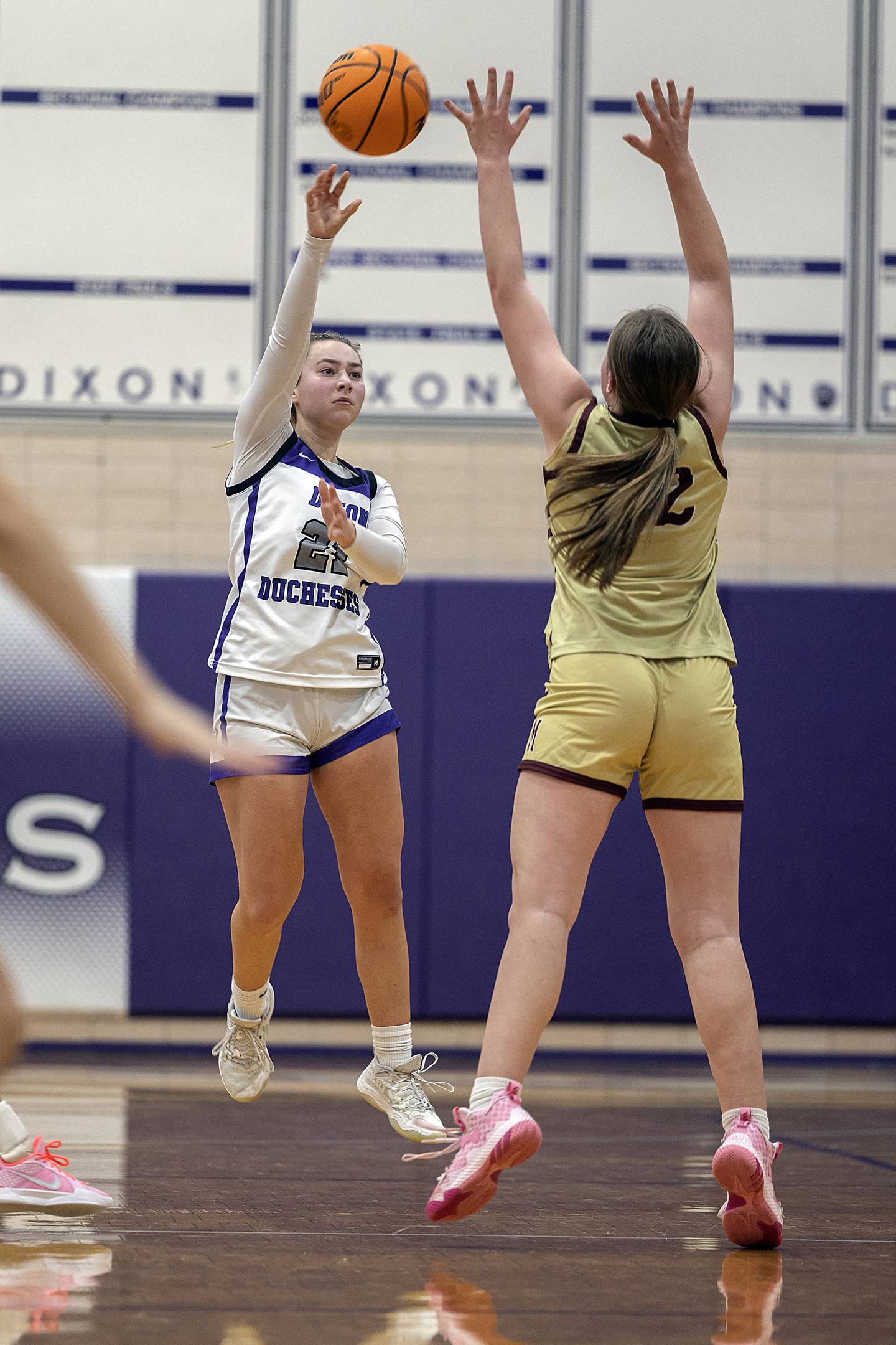Dixon's Reese Dambman passes the ball over Morris’ Layken Callahan Friday, Jan. 3, 2025, at Dixon High School.
